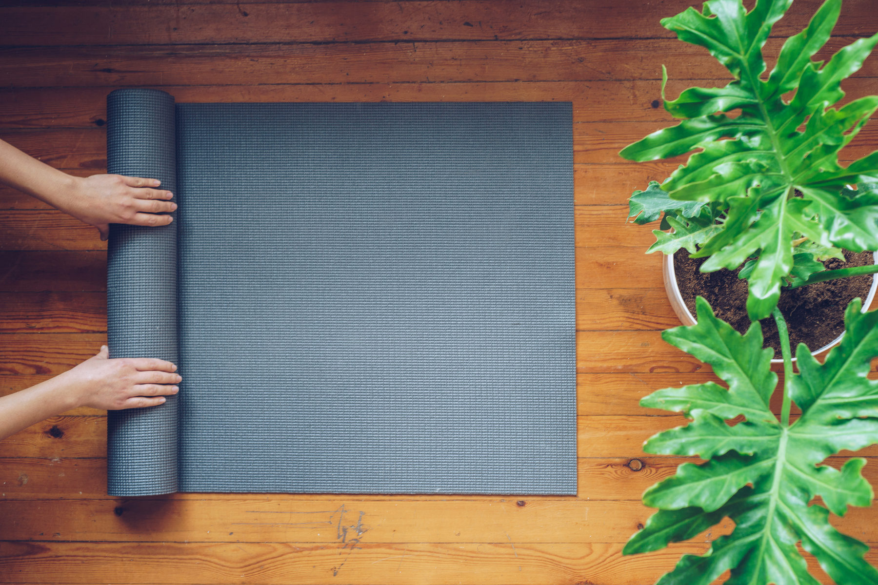 Woman Rolling Mat after Yoga